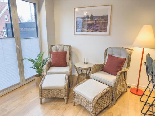 a living room with two chairs and a table at Tiny House in Lorup