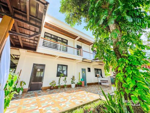 an image of a house with a courtyard at THE OASIS RESORT CondoBimbo 1-Big Room, Balcony, kitchen, Pool, Wifi, Videoke in San Fernando