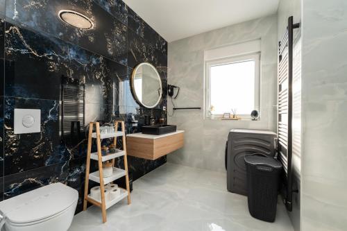a bathroom with a toilet and a sink and a mirror at New - Luxury Villa Angel - private pool in Vir