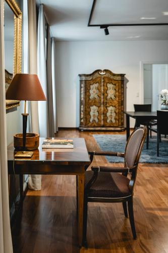 a living room with a table and chairs and a piano at My Wonderland in Salzburg