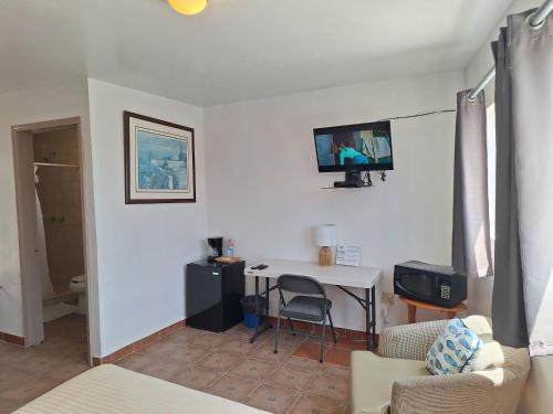 a living room with a desk and a tv on the wall at #44#27#56al#67 Rooms 2 beds near beach in San Felipe