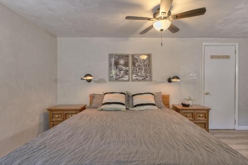 a bedroom with a bed with a ceiling fan at Serene and Secluded Walk Up in the Woods in Ligonier