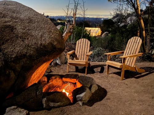 two chairs sitting next to a fire pit at Cozy Dome Hideaway with Sweeping Sunrise View in Fallbrook