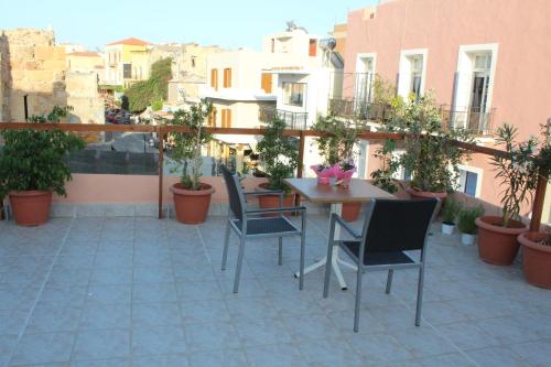 a patio with a table and chairs on a balcony at My Rooms in Chania Town