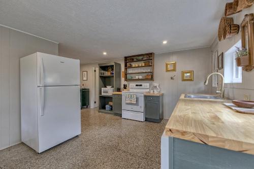 a kitchen with a white refrigerator and a sink at Surrender to Tranquility - Feather Ledge Cliffwood Colony in Ligonier