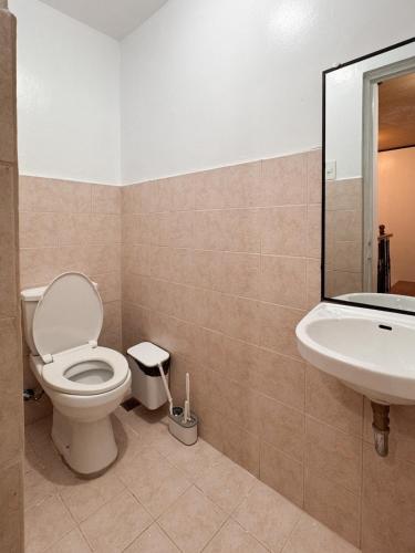 a bathroom with a toilet and a sink at The Nook 12 in Malolos