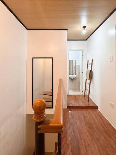 a hallway with a mirror and a staircase in a room at The Nook 12 in Malolos