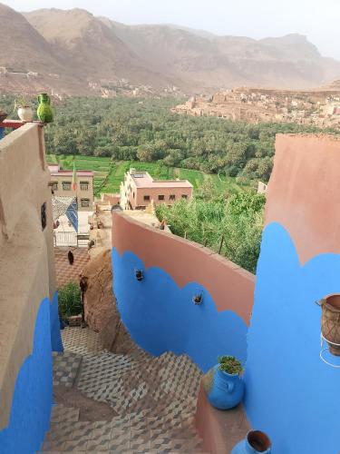 a view from the balcony of a house with blue at Auberge ALI Todra A Natural Oasis in Tinerhir