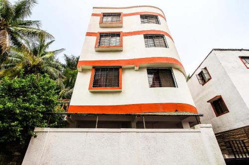 a building with an orange stripe on the side of it at Hotel O Galaxy Near INOX in Yeraoda