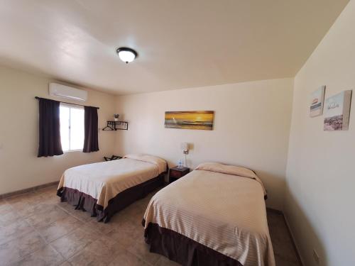 a room with two beds and a window at #44#27#56al#67 Rooms 2 beds near beach in San Felipe