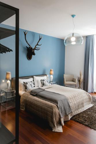 a bedroom with a bed with a blue wall at My Wonderland in Salzburg
