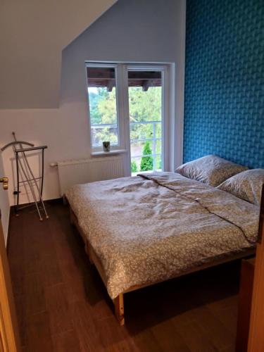 a bedroom with a bed and a window at Bliźniak Swornegacie in Swornegacie 