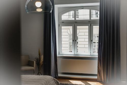 a bedroom with a window and a bed and a chair at My Wonderland in Salzburg