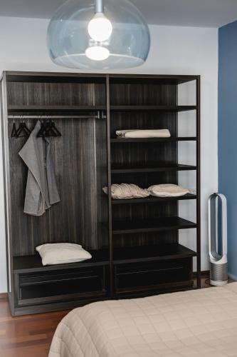 a black closet with a bed and a television at My Wonderland in Salzburg