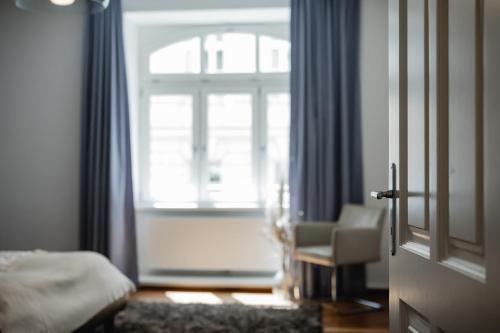 a bedroom with a bed and a window and a chair at My Wonderland in Salzburg