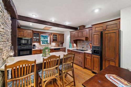 a kitchen with wooden cabinets and a table and chairs at Warm Historic Mountain Cabin in Champion