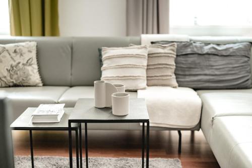 a living room with a couch and two coffee tables at My Wonderland in Salzburg