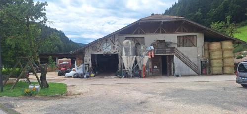 a building with a garage with a snowboard in it at Appartamenti Agritur Mas da la Val in Ronzone