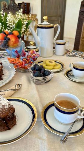 a table with plates of food and cups of coffee at Residenza Rinascimento 