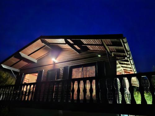a house with a porch with a light on it at Le Belle Homme in Gouvy