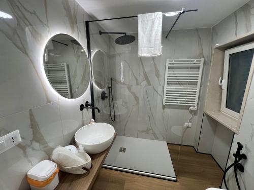 a bathroom with a sink and a mirror at Casetta Aurora in Bari