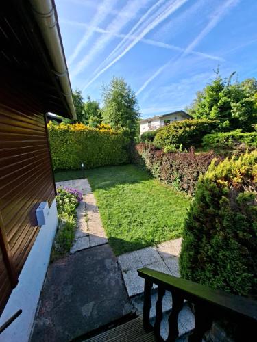 a view of a yard with a bench at Le Belle Homme in Gouvy