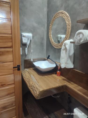 a bathroom with a wooden sink and a mirror at POUSADA NOSSO CANTO ALTER in Alter do Chao