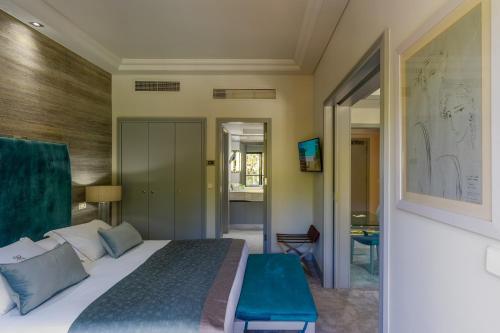 a bedroom with a large bed with a blue bench at Rodos Park in Rhodes Town