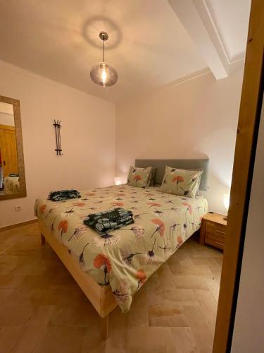 a bedroom with a bed in a room at Almada Negreiros in Vila Nova de Milfontes