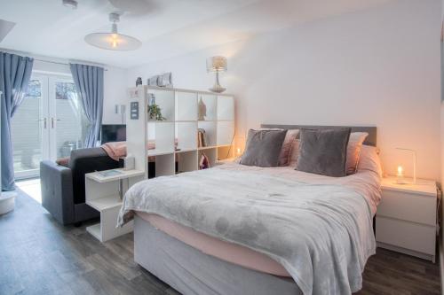a bedroom with a large bed and a chair at Portway Nook - 1 Bedroom Studio - Bishopston in Bishopston