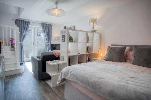 a bedroom with a large bed and a couch at Portway Nook - 1 Bedroom Studio - Bishopston in Bishopston