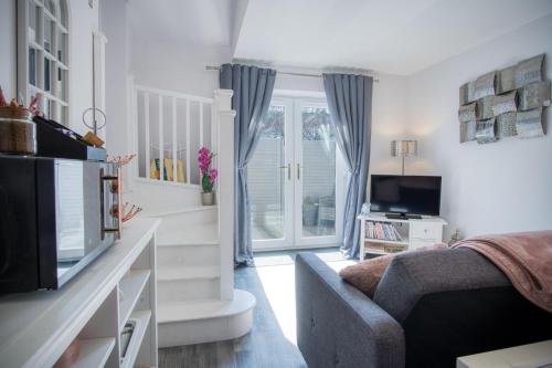 a living room with a couch and a tv at Portway Nook - 1 Bedroom Studio - Bishopston in Bishopston