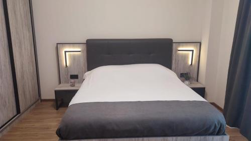 a bedroom with a large bed with two night stands at ALVINA Complex Tsaghkadzor in Tsaghkadzor