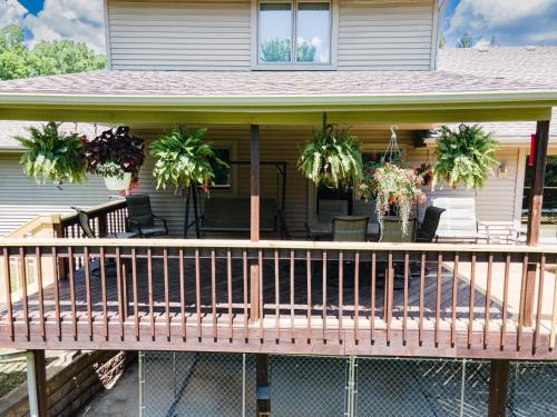 a porch with potted plants on a house at Whispering Woods Estate - Relax, Recharge, Connect - 12 wooded acres, 3 Bedrooms, 3 Baths, sleeps 10 in Rockton