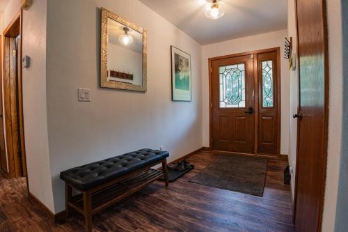 a hallway with a bench in front of a door at Whispering Woods Estate - Relax, Recharge, Connect - 12 wooded acres, 3 Bedrooms, 3 Baths, sleeps 10 in Rockton