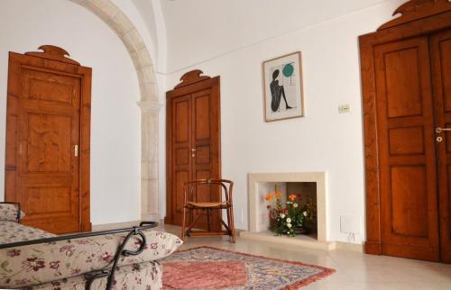 a living room with a couch and a fireplace at La Bocciarda in Ceglie Messapica