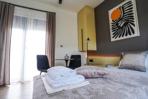 a bedroom with a bed with towels on it at Vila Karlovčanka smeštaj u centru Sremskih Karlovaca in Sremski Karlovci