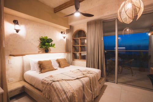 a bedroom with a bed and a large window at Mediterranean Apartment, CB510 in Estación El Salto