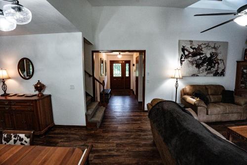 a living room with a couch and a table at Whispering Woods Estate - Relax, Recharge, Connect - 12 wooded acres, 3 Bedrooms, 3 Baths, sleeps 10 in Rockton