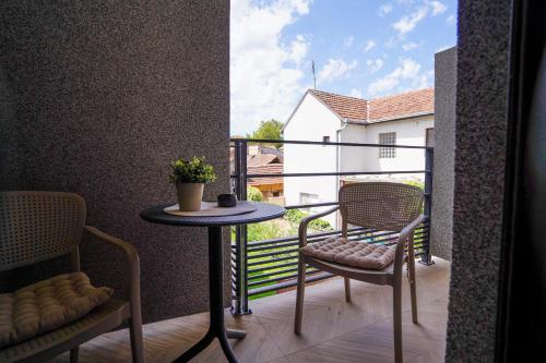 a balcony with two chairs and a table on a balcony at Vila Karlovčanka smeštaj u centru Sremskih Karlovaca in Sremski Karlovci