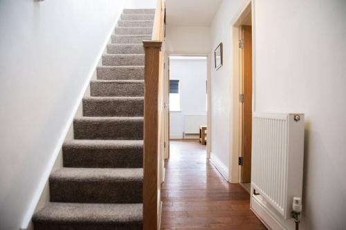 a staircase in a home with a stair case at Academy Apartments By Elegance Stays in Hull