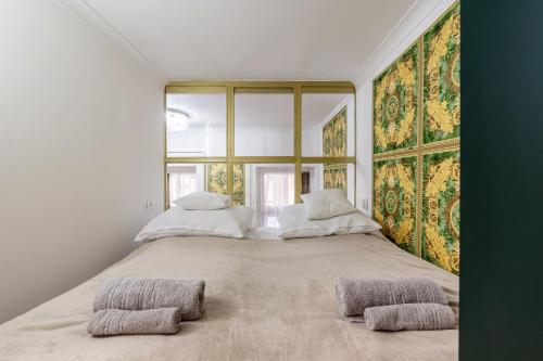 a bedroom with two beds and a large window at Csarnok Apartment in Budapest