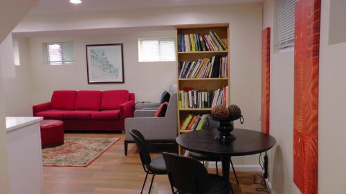 a living room with a red couch and a table at Lincoln Howard House in Washington, D.C.