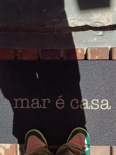 a persons shadow of a persons shoes on the street at Dendê Jazz Hostel e Pousada in Morro de São Paulo