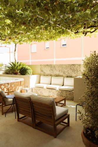 a patio with couches and a table and chairs at Apartments Toni in Split