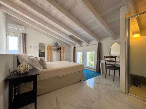 a bedroom with a large bed and a table at Tenuta Feraxi - Private Paradise in San Priamo
