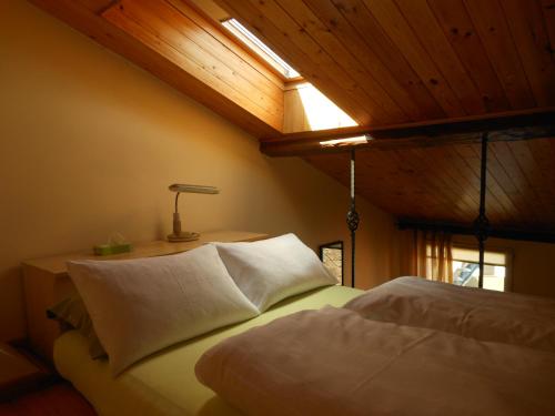 a bedroom with a bed with a light on the ceiling at Daukanto Apartments in Vilnius