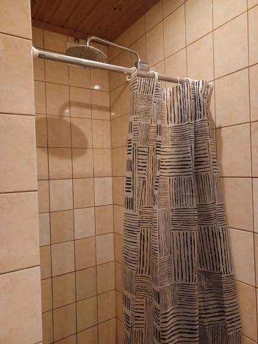 a shower curtain is hanging in a bathroom at countryside next to center in Kemi