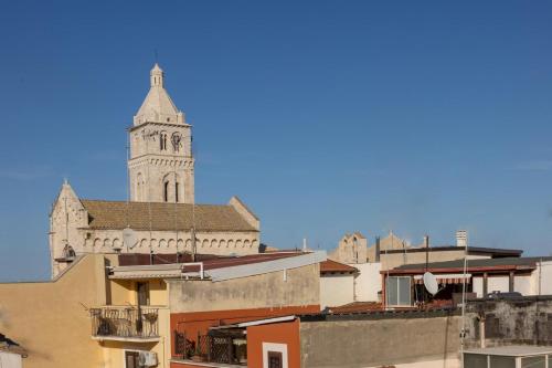a church with a clock tower in a city at My Home in Barletta