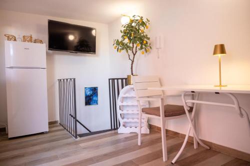 a kitchen with a white table and a white refrigerator at My Home in Barletta